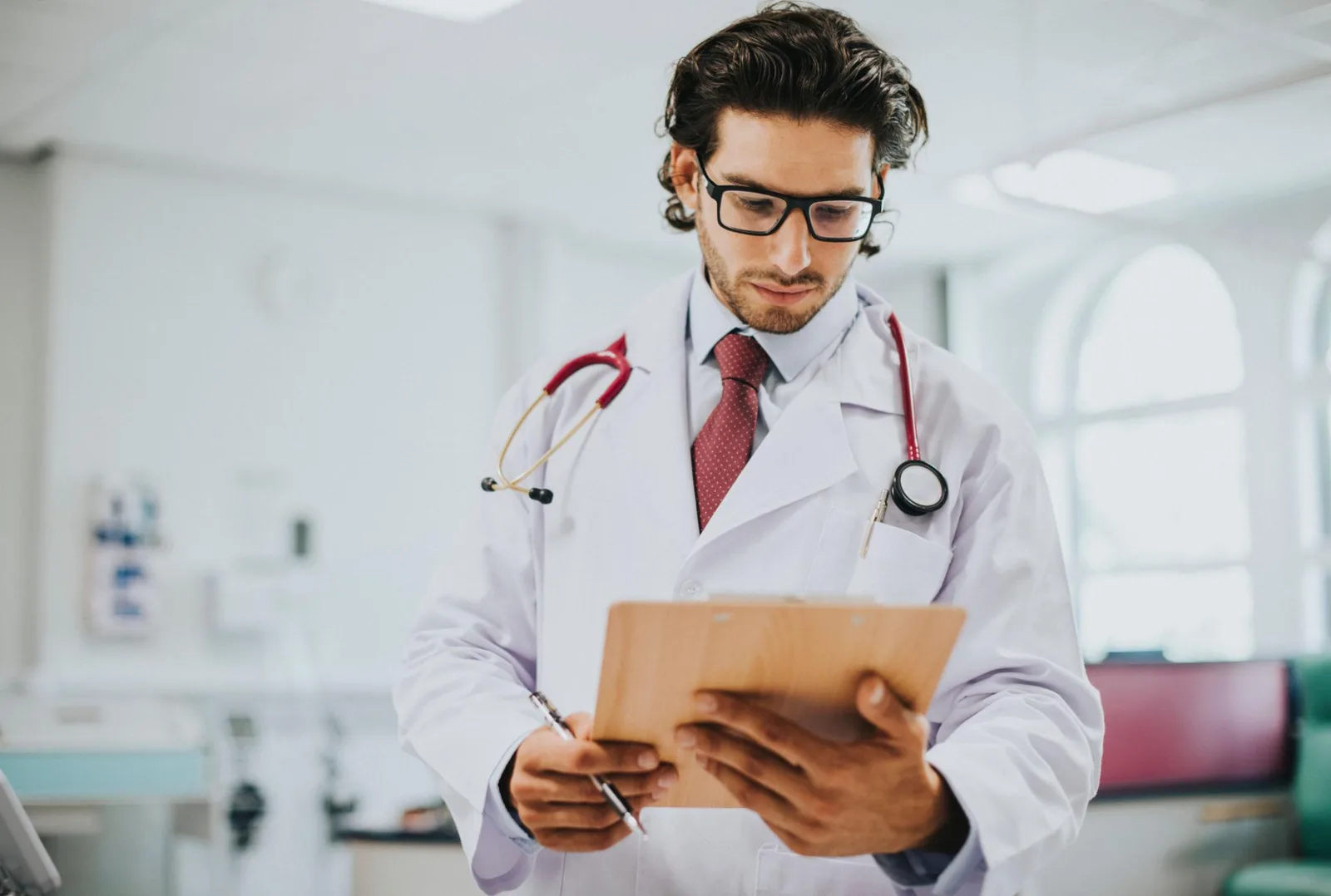 Physician reviewing a patient's clinical report at a desk